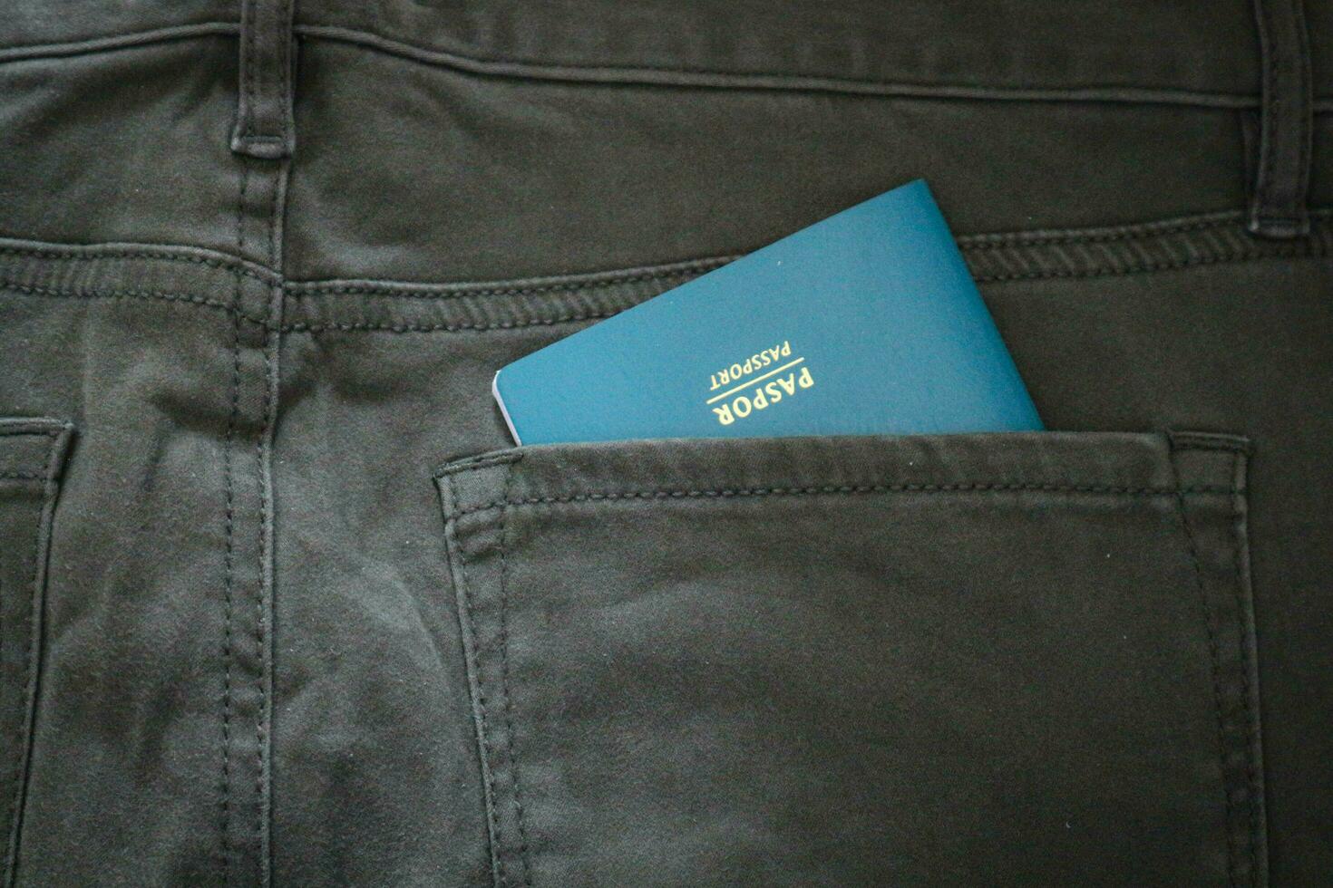 An Indonesian citizenship passport in a green denim pocket. photo