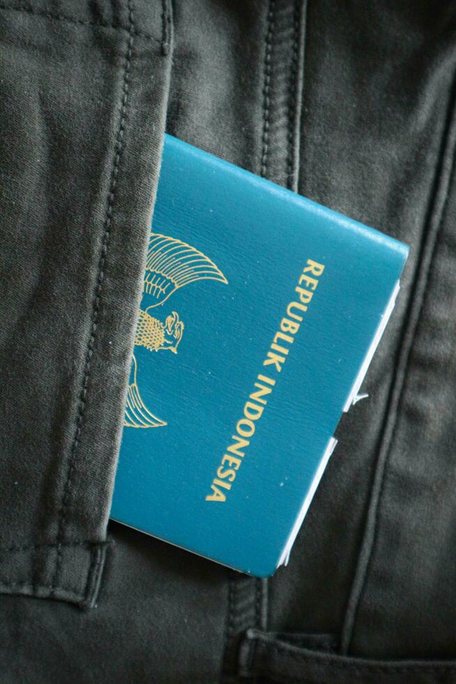 An Indonesian citizenship passport in a green denim pocket. photo