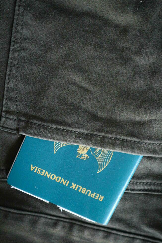 An Indonesian citizenship passport in a green denim pocket. photo