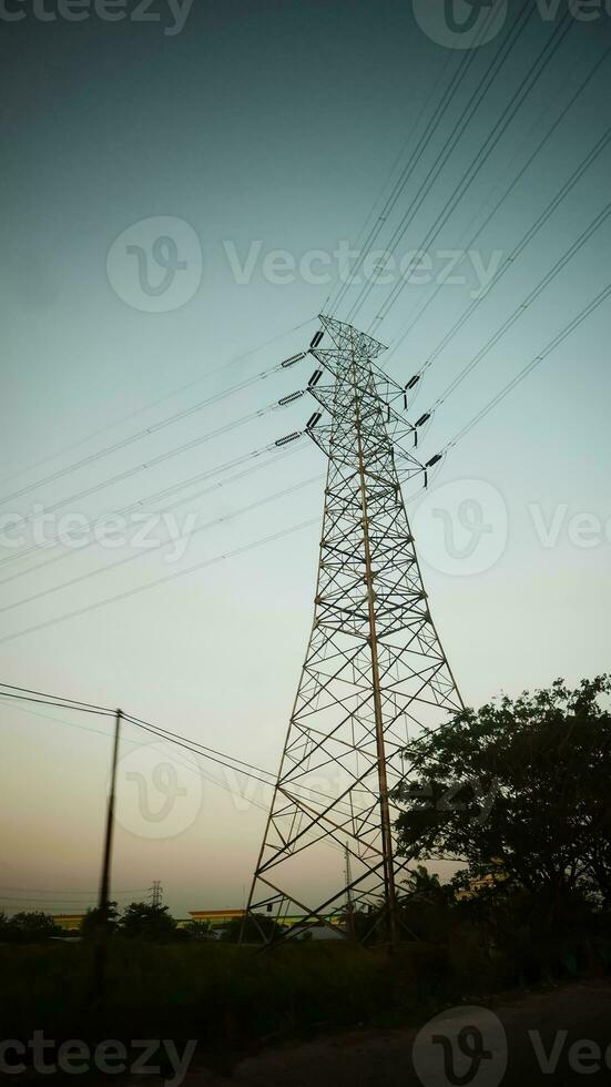 communication tower, electrical tower, power grip, telecommunication tower, mobile phone relay tower, with cables and other technological background photo