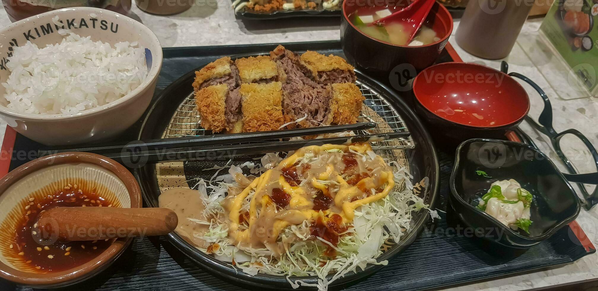 Indonesian japanese fusion food, japanese food cook in indonesian style, gyukatsu, beef karage, salad, and tofu soup photo