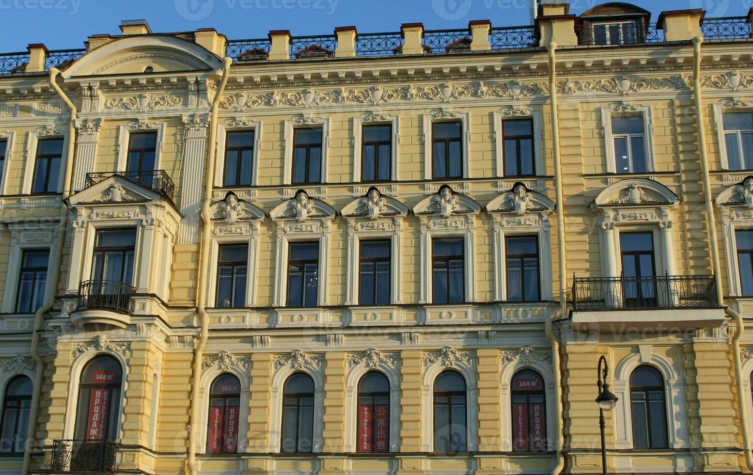 Old Historic Building Facade of Soft Yellow and White Color with Windows in Saint Petersburg, Russia. Classic Russian City House Exterior, Front View of Traditional European Style Building in Russia. photo
