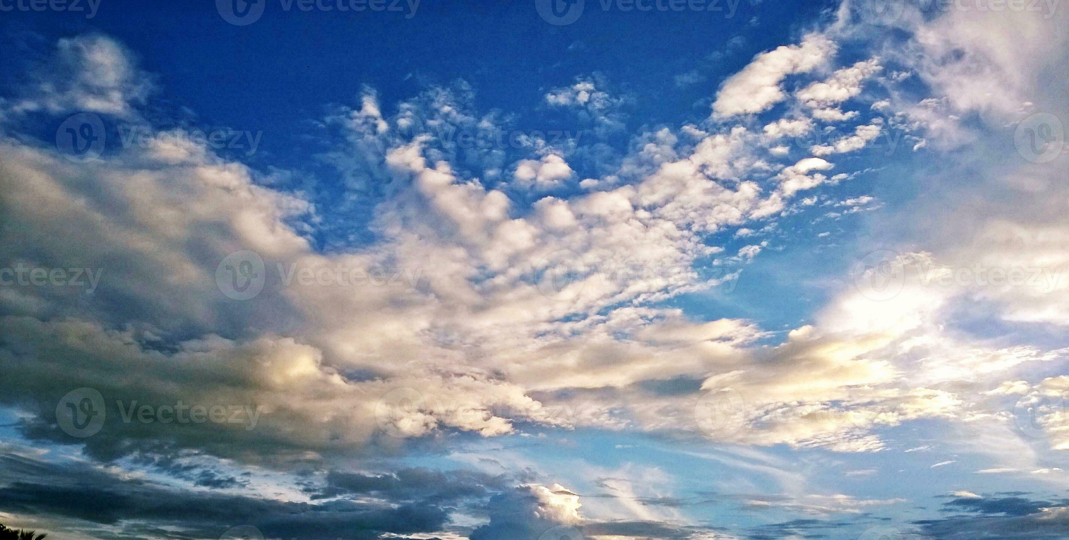 Closeup background and texture of bright blue sky and cotton clouds with  sun lights on afternoon summer. 27002375 Stock Photo at Vecteezy