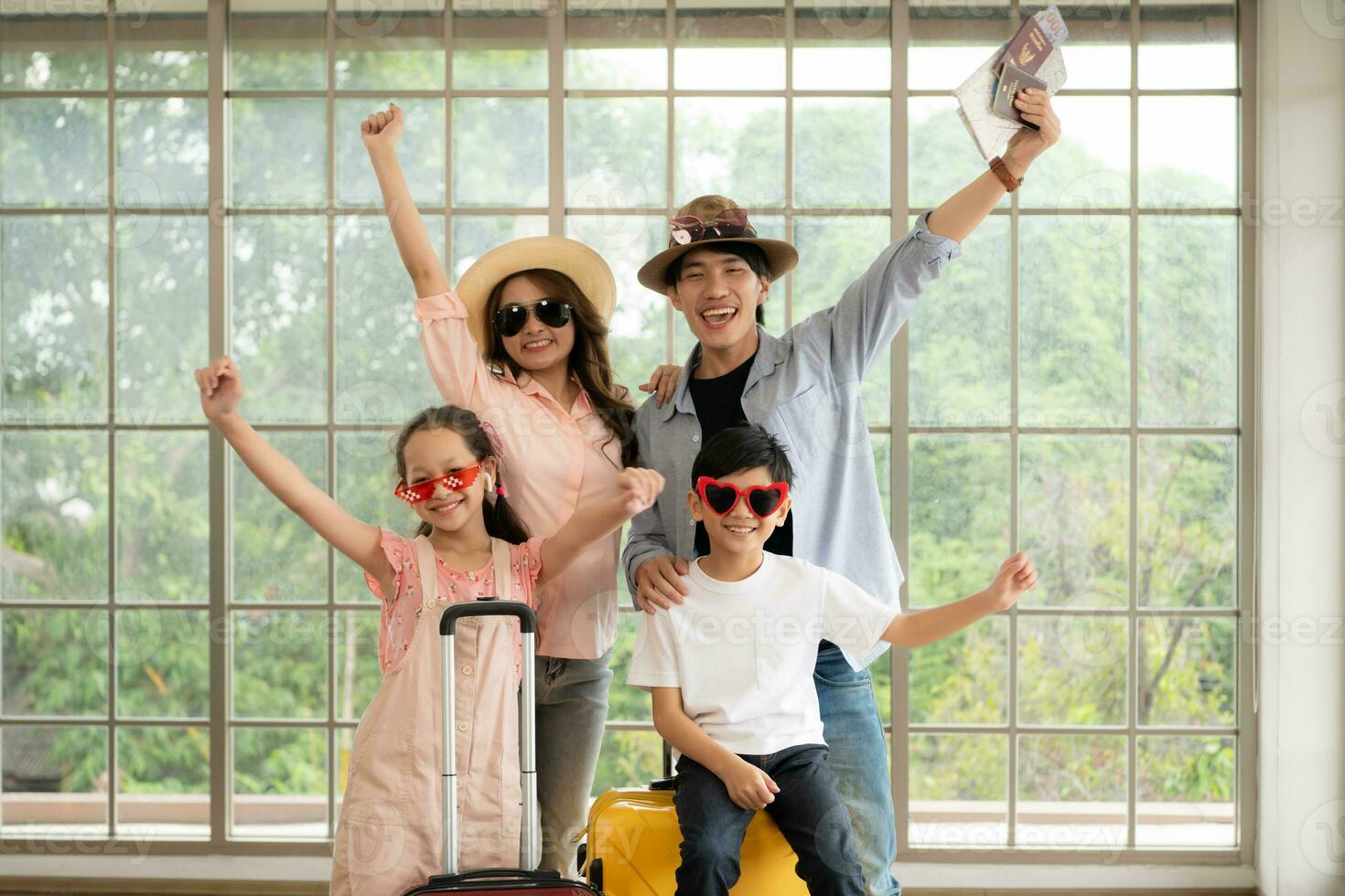 Father, mother, son and daughter packing for a weekend trip and  ready to go. photo