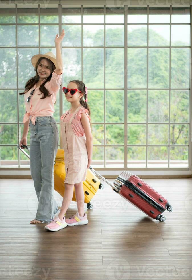 Mother and daughter are happy and ready to travel on a weekend trip photo