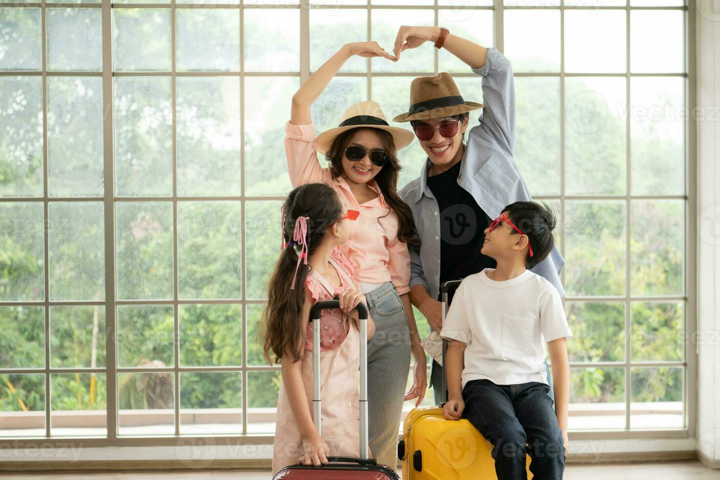 Father, mother, son and daughter packing for a weekend trip and  ready to go. photo