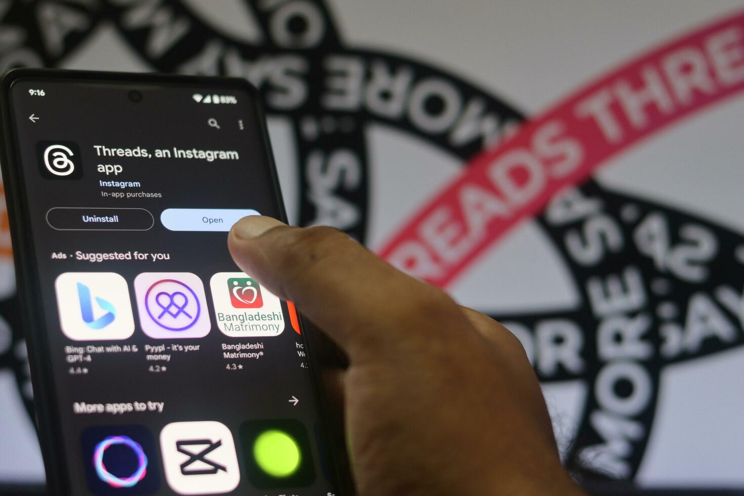 installing Threads app on a phone, The threads logo is displayed on a smartphone screen. Threads new social network, Say More Campaign by Threads, Threads Instagram, July 20, 2023 - Dhaka, Bangladesh photo