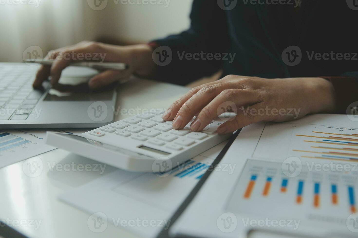 Unrecognizable businessman using calculator photo
