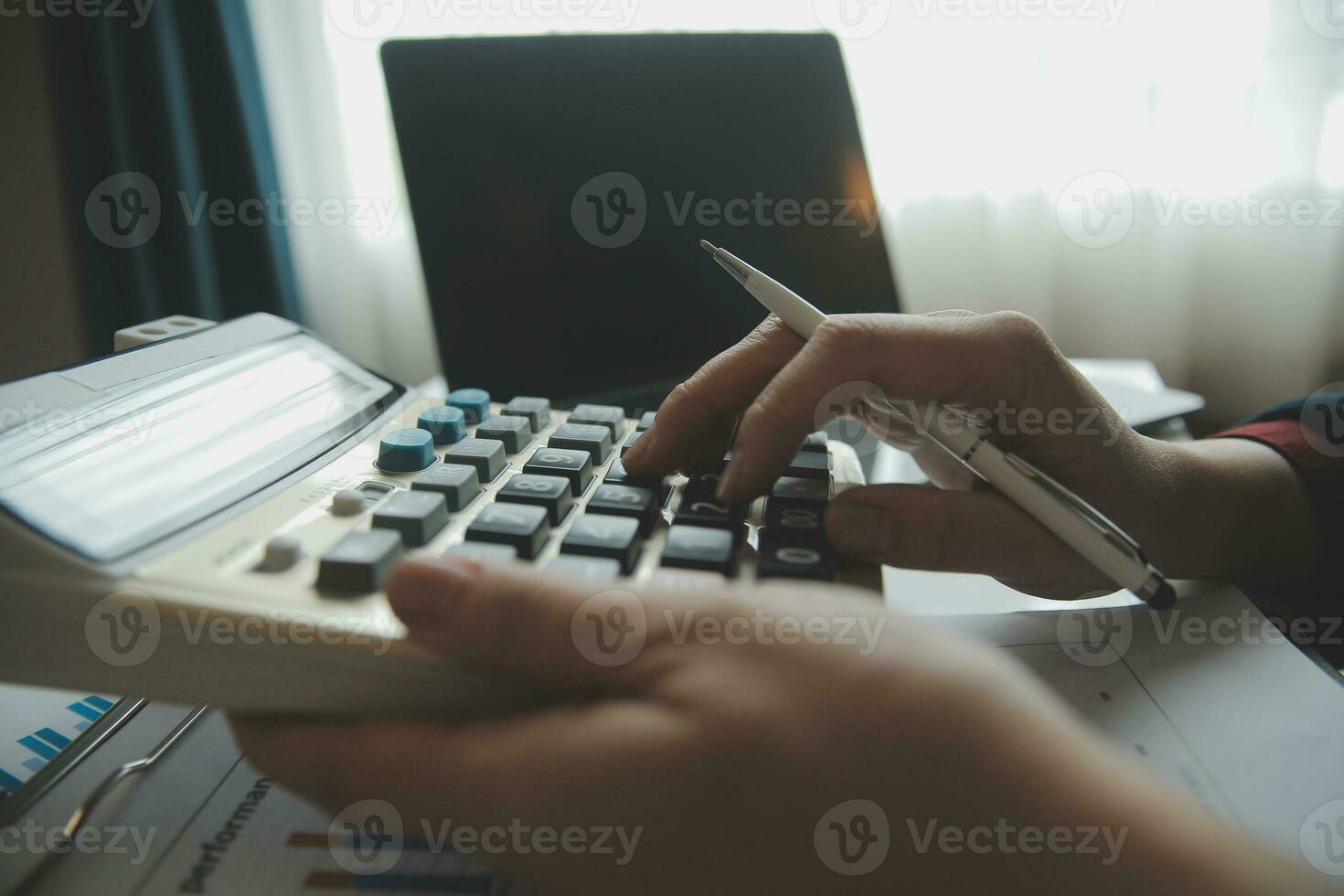 Unrecognizable businessman using calculator photo
