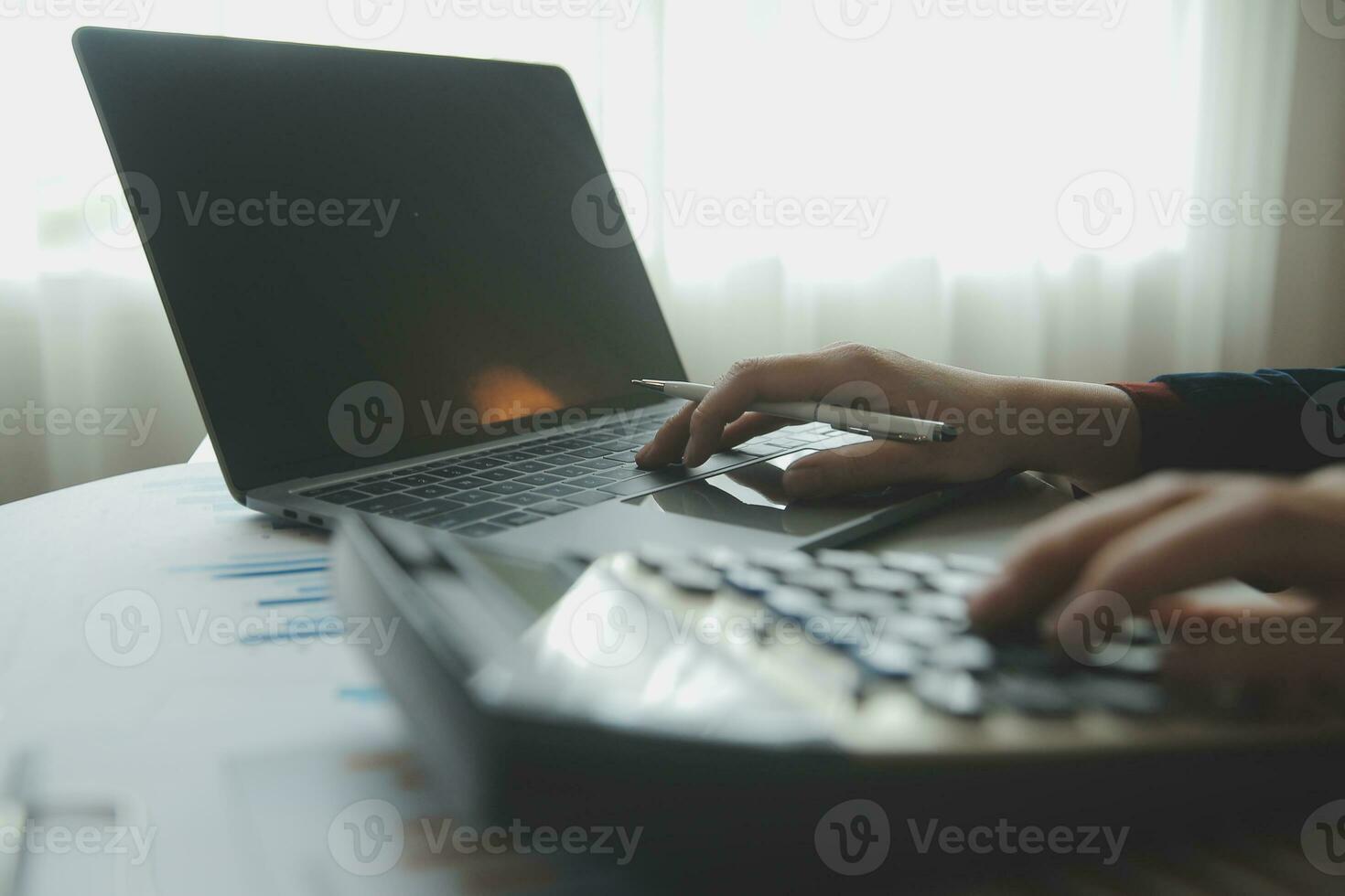Unrecognizable businessman using calculator photo