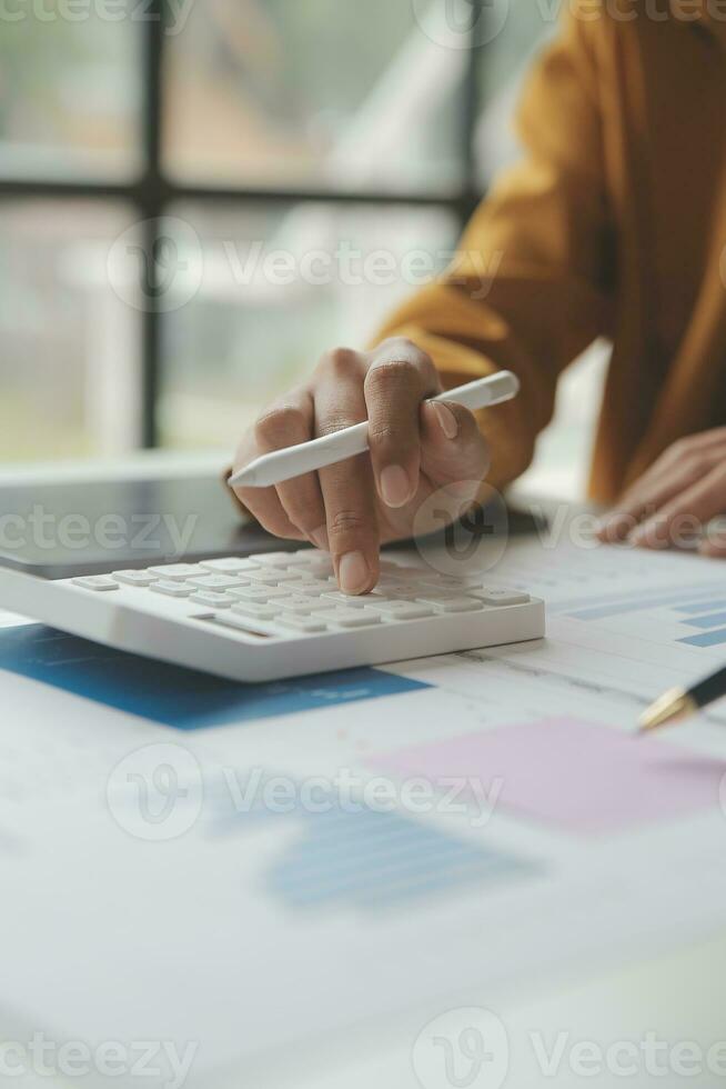 Accounting businessman working on laptop computer and analyzing real estate investment data, Financial and tax systems concept. photo