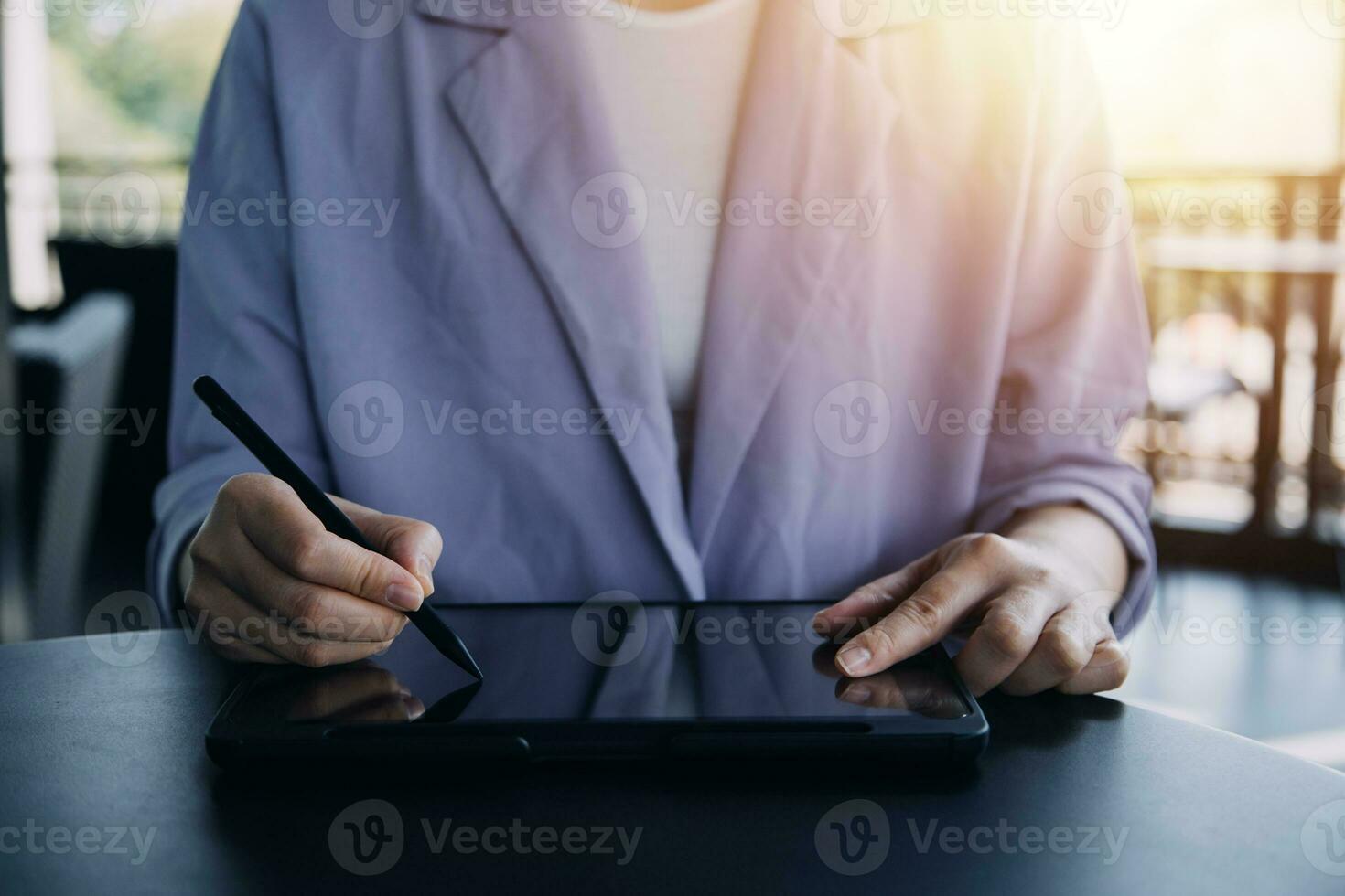 Asian Business woman using calculator and laptop for doing math finance on an office desk, tax, report, accounting, statistics, and analytical research concept photo