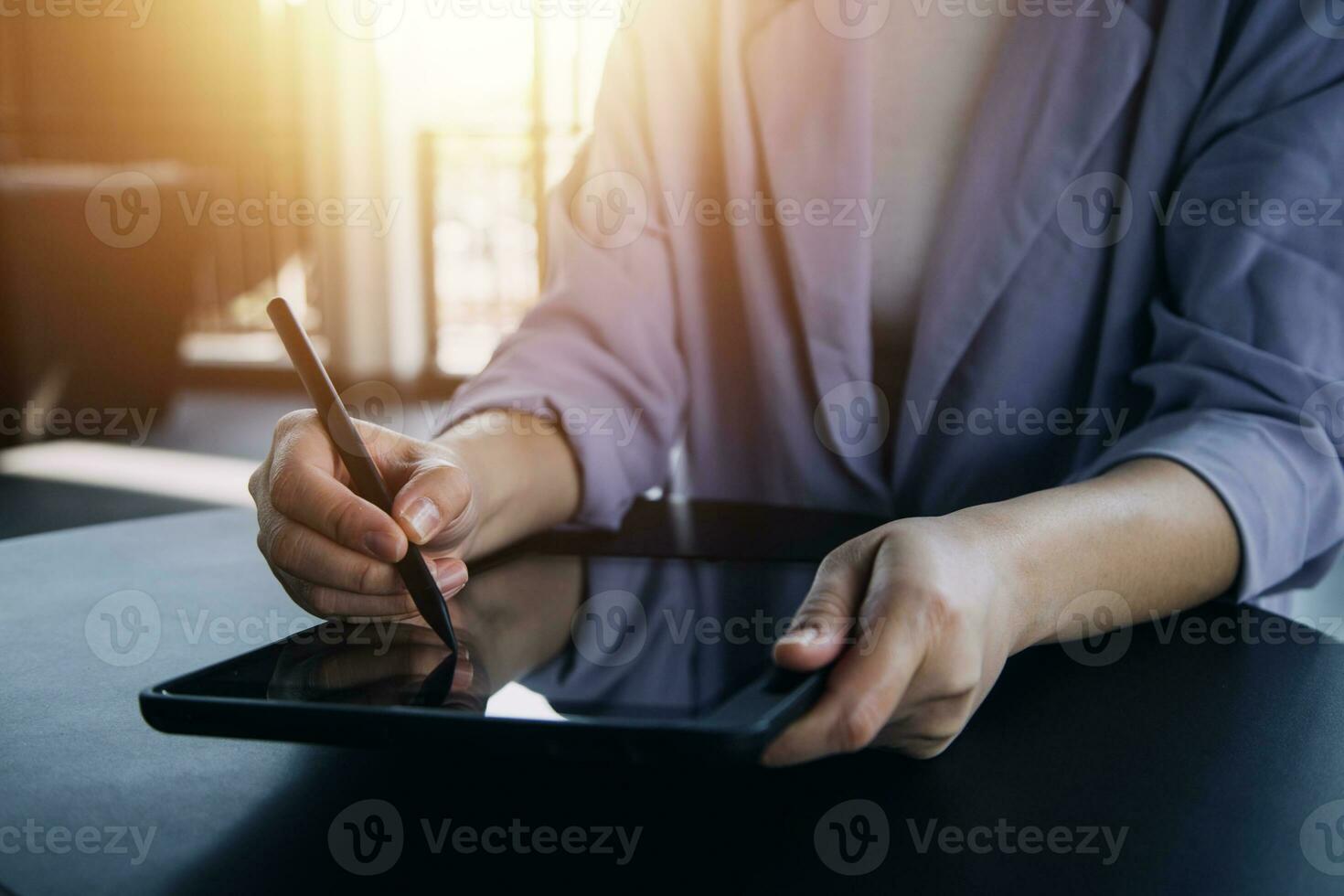 Asian Business woman using calculator and laptop for doing math finance on an office desk, tax, report, accounting, statistics, and analytical research concept photo