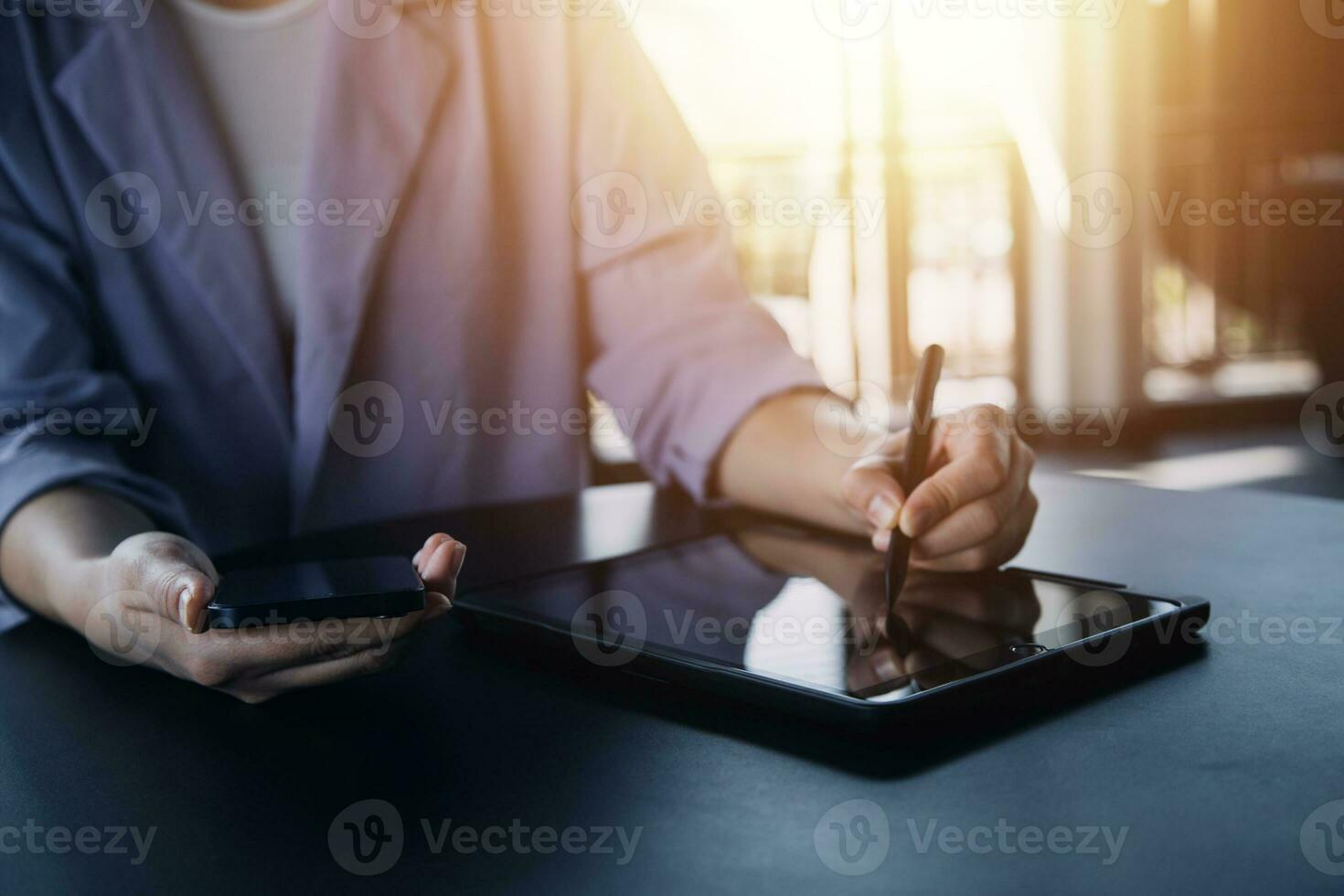 Asian Business woman using calculator and laptop for doing math finance on an office desk, tax, report, accounting, statistics, and analytical research concept photo