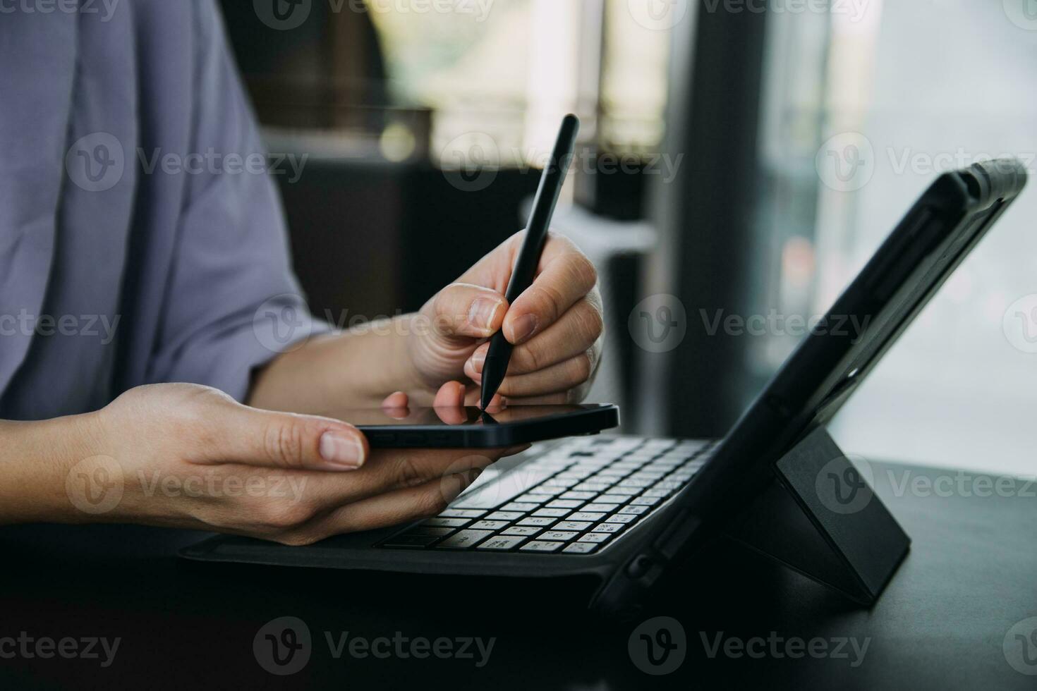Asian Business woman using calculator and laptop for doing math finance on an office desk, tax, report, accounting, statistics, and analytical research concept photo