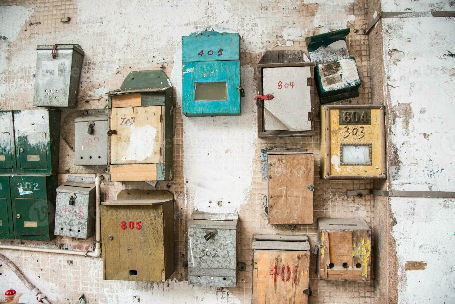 Old different mailboxs on the old wall photo