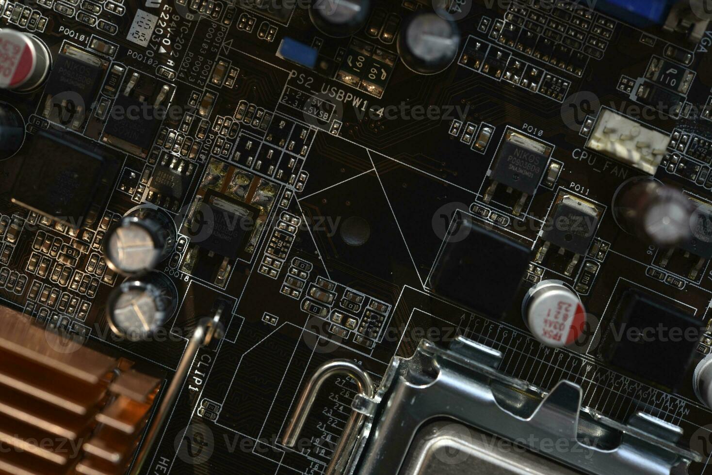 The processor of the computer on the motherboard. Electronic elements and a processor in a computer. photo