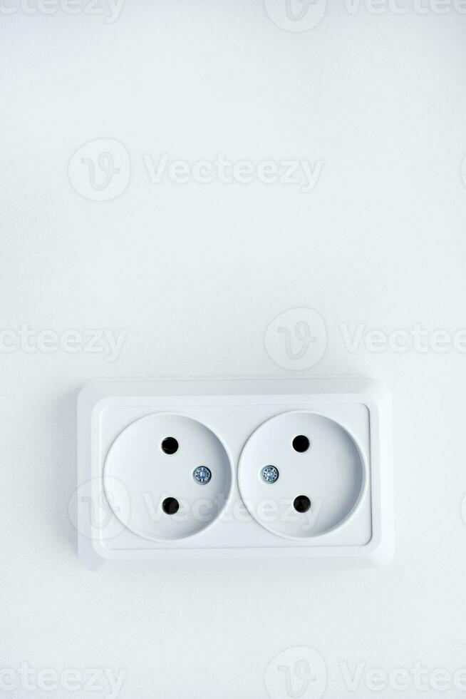 White double electrical outlet on a white background. Eurozette closeup. Electrical appliance