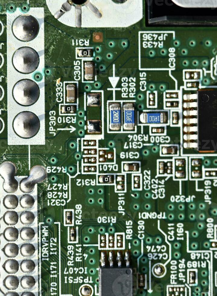 Blue board with radio elements. A chip with a processor and transistors. Diodes and resistors. Microchip. photo