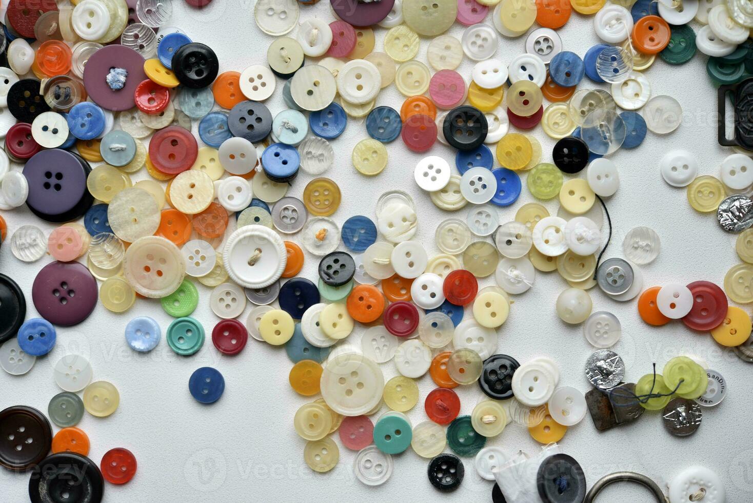 Multicolored buttons on a white background. Round buttons from clothes. photo