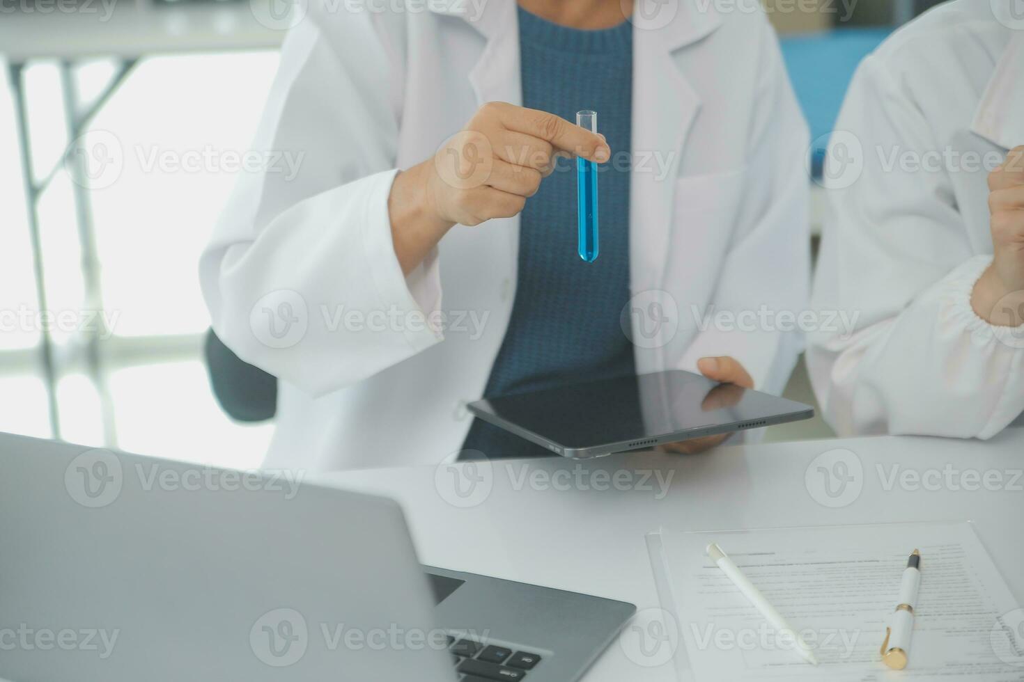 Team of Scientists Choose Between Printed Circuit Board to Work With. In The Background Technologically Advanced Scientific Research Center. photo