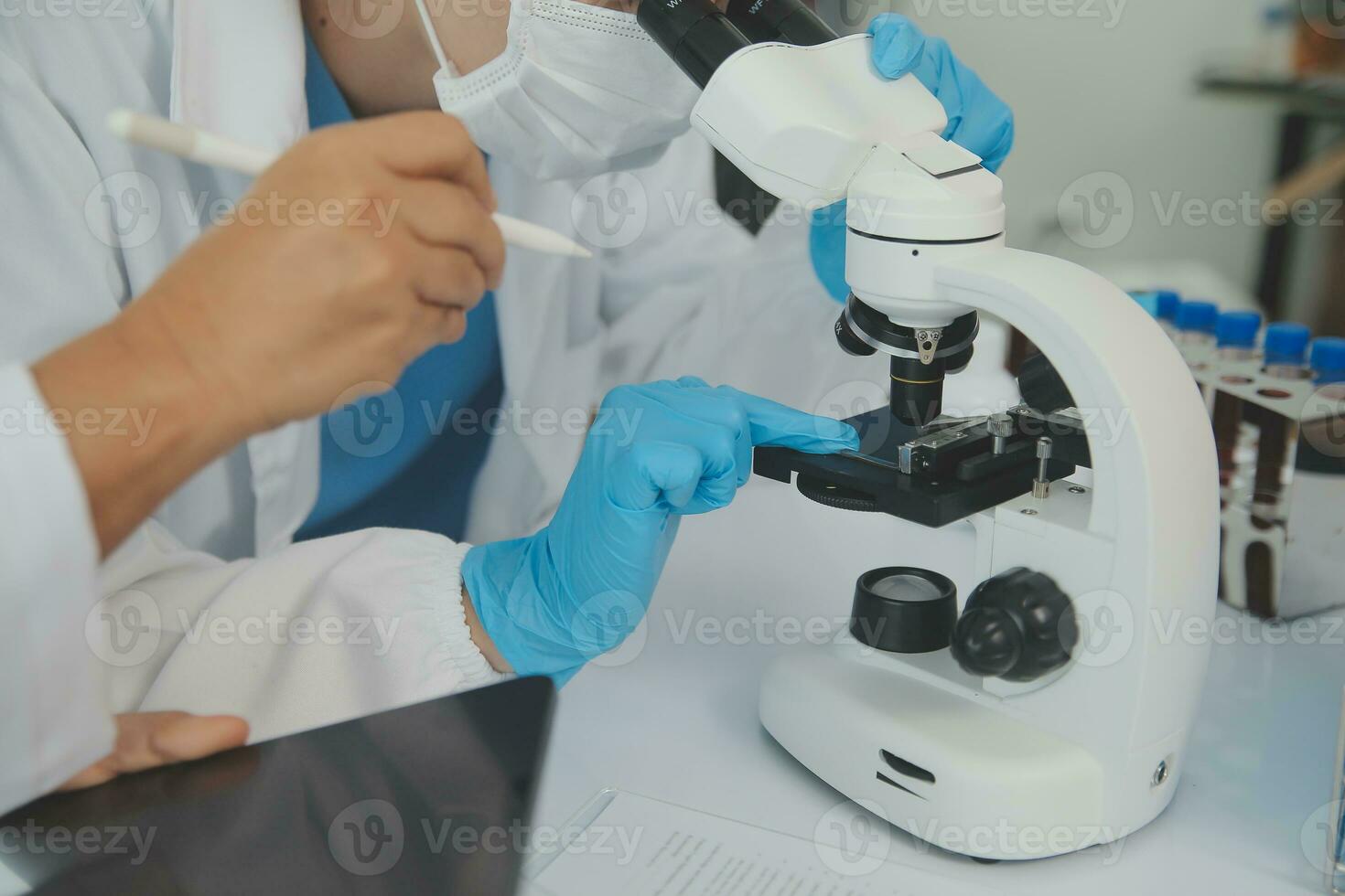 Team of Scientists Choose Between Printed Circuit Board to Work With. In The Background Technologically Advanced Scientific Research Center. photo