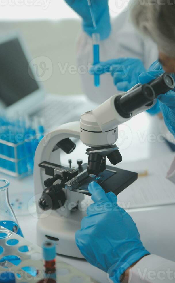 Team of Scientists Choose Between Printed Circuit Board to Work With. In The Background Technologically Advanced Scientific Research Center. photo