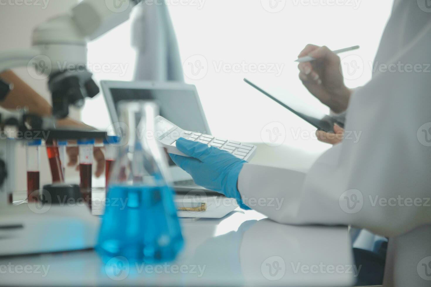 Team of Scientists Choose Between Printed Circuit Board to Work With. In The Background Technologically Advanced Scientific Research Center. photo