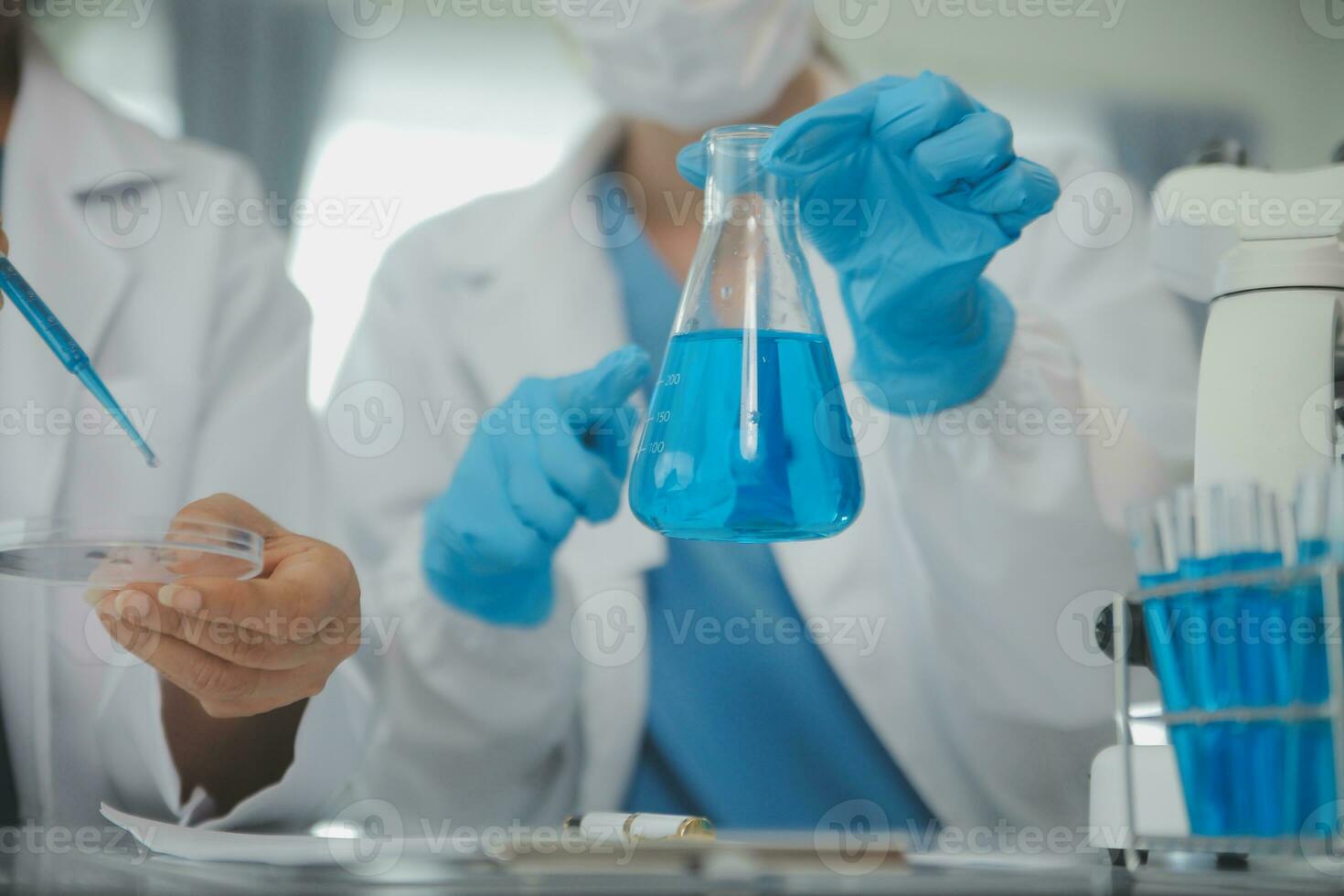 Team of Scientists Choose Between Printed Circuit Board to Work With. In The Background Technologically Advanced Scientific Research Center. photo