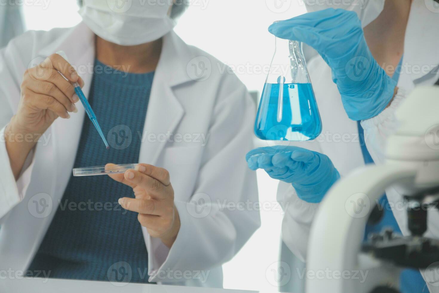 Team of Scientists Choose Between Printed Circuit Board to Work With. In The Background Technologically Advanced Scientific Research Center. photo