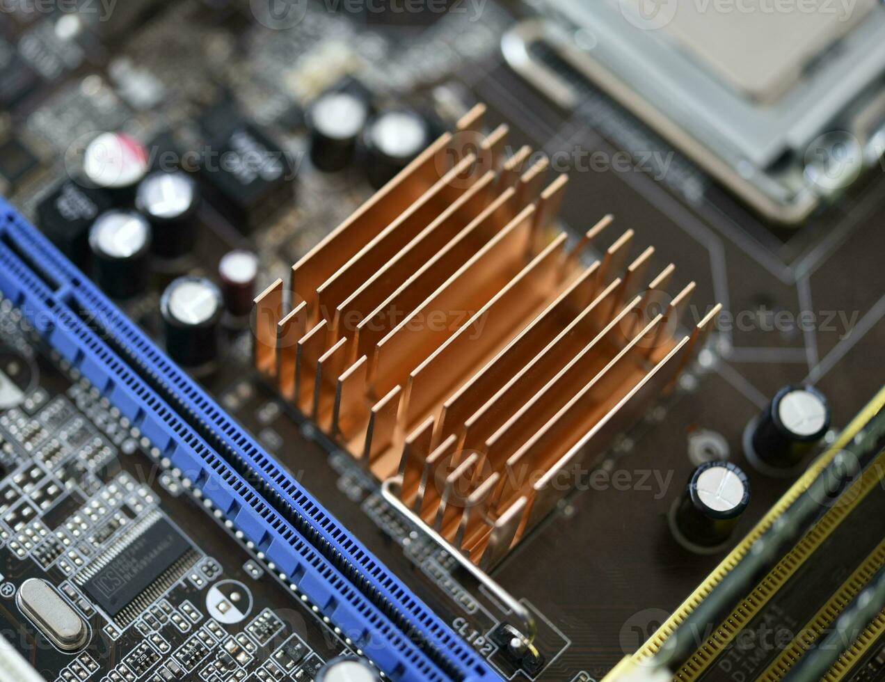 The processor of the computer on the motherboard. Electronic elements and a processor in a computer. photo