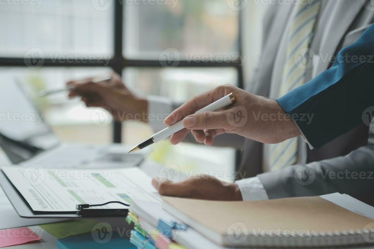 analyst or financial advisor provides advice on securities analysis and stock market management. Businessman showing documents through graphs and charts. Brainstorm and work together photo
