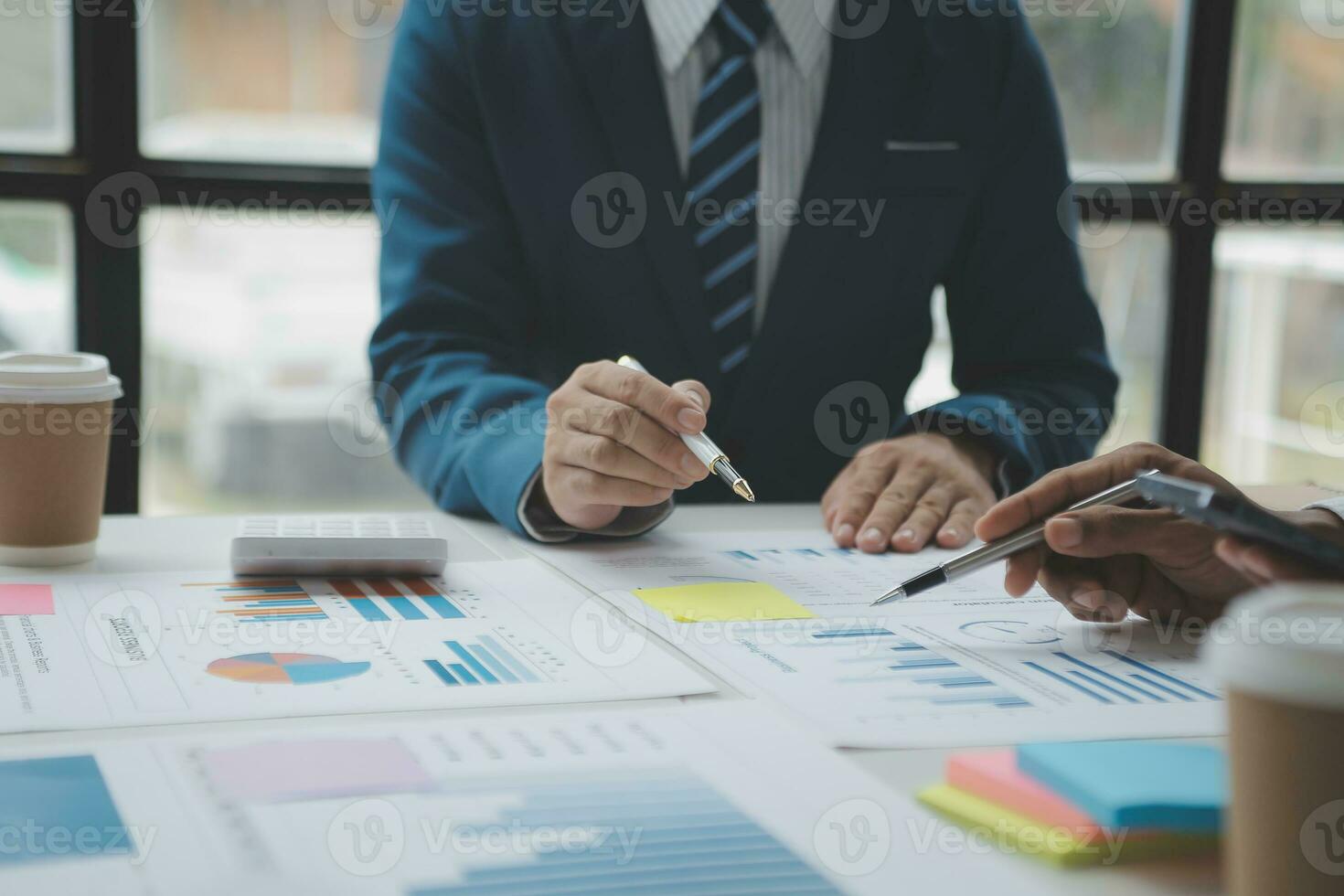 analyst or financial advisor provides advice on securities analysis and stock market management. Businessman showing documents through graphs and charts. Brainstorm and work together photo