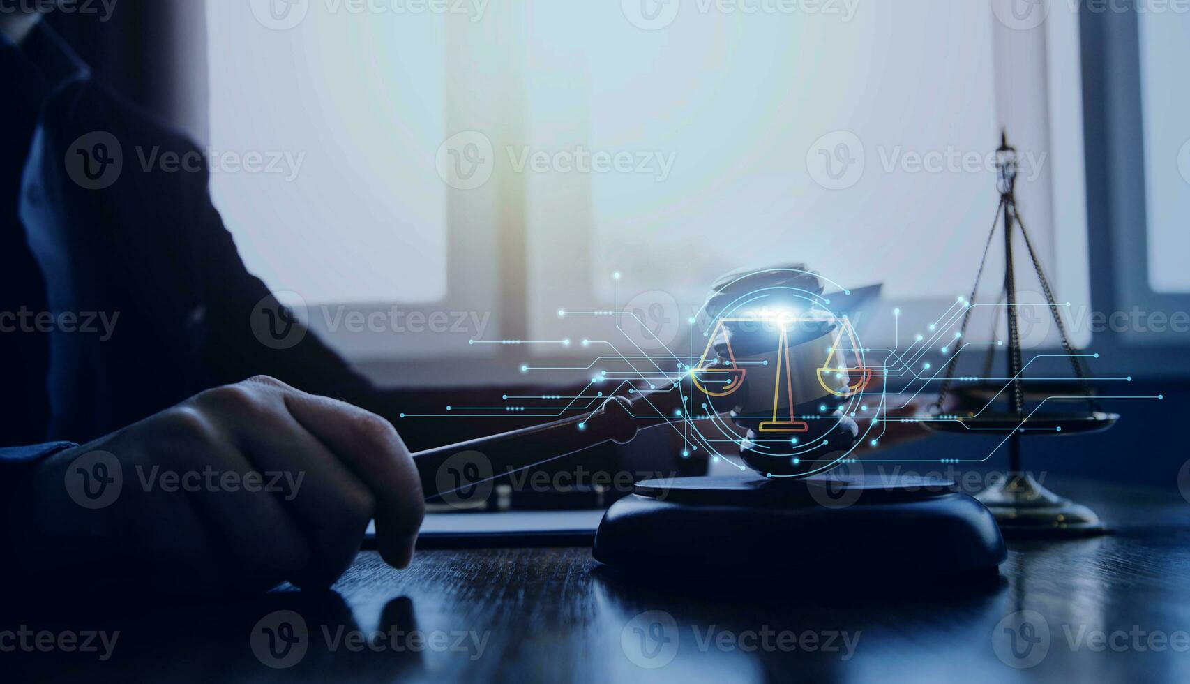 Justice and law concept.Male judge in a courtroom with the gavel, working with, computer and docking keyboard, eyeglasses, on table in morning light photo