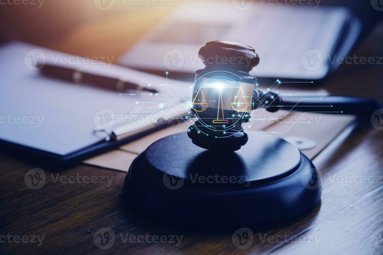 Justice and law concept.Male judge in a courtroom with the gavel, working with, computer and docking keyboard, eyeglasses, on table in morning light photo