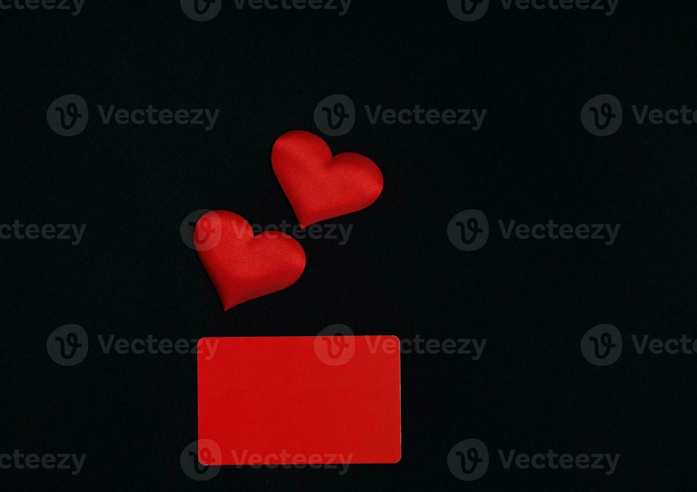 Red hearts, red horizontal rectangle on a black background. Valentines day concept. Border, copy space, top view, celebration, holiday photo