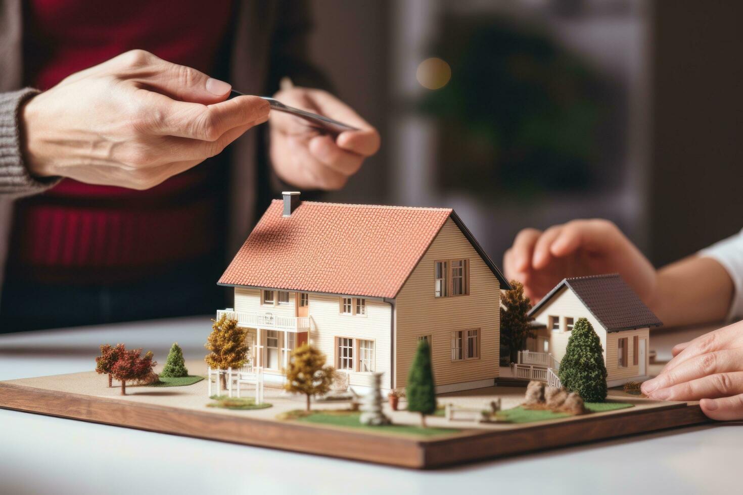 A couple on a desk with a house model and house keys photo