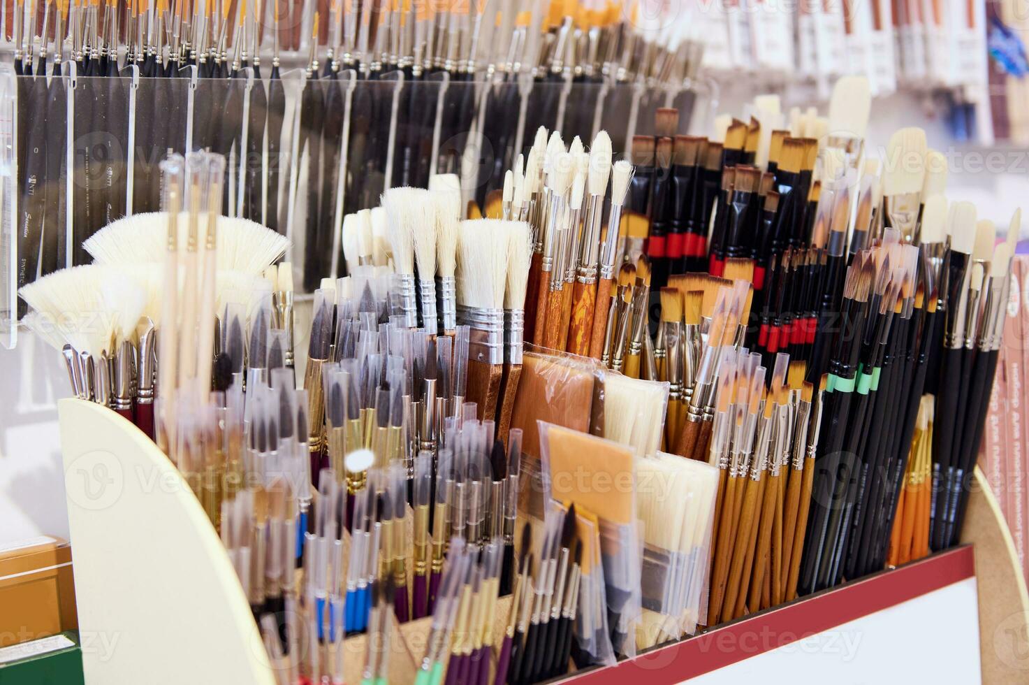 Assortment of paintbrushes on display shelf in an art store or school supplies shop. Fine art. Painting tools. Close-up photo