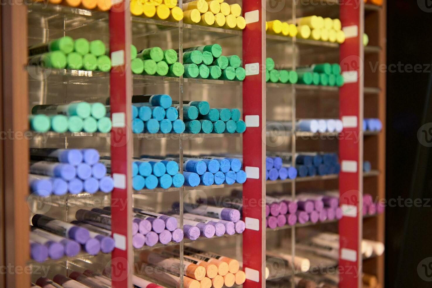 A shelf with colorful pastel crayons of vibrant colors displayed for sale in the school stationery store. Drawing tools photo