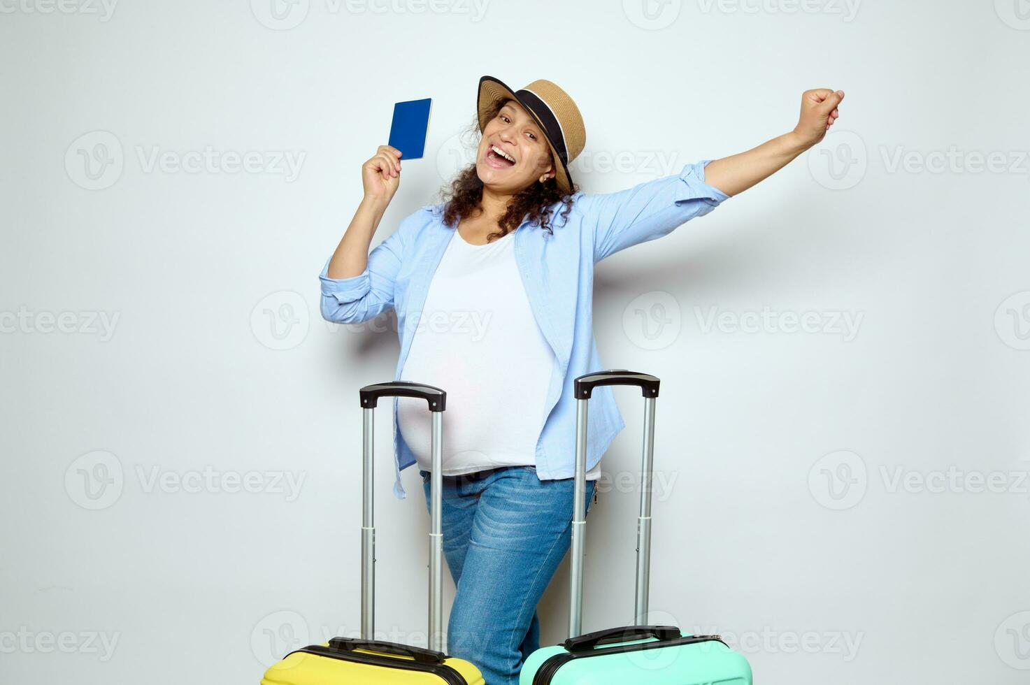 Happy pregnant woman holding passport, expressing positive emotions, traveling abroad, going on summer holidays. Tourism photo