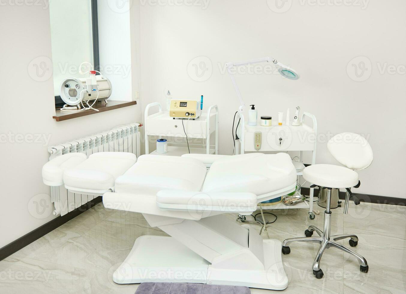 Interior of modern beauty room equipped with modern apparatus and medical equipments for skin treatment and beauty therapy in contemporary luxury spa clinic photo