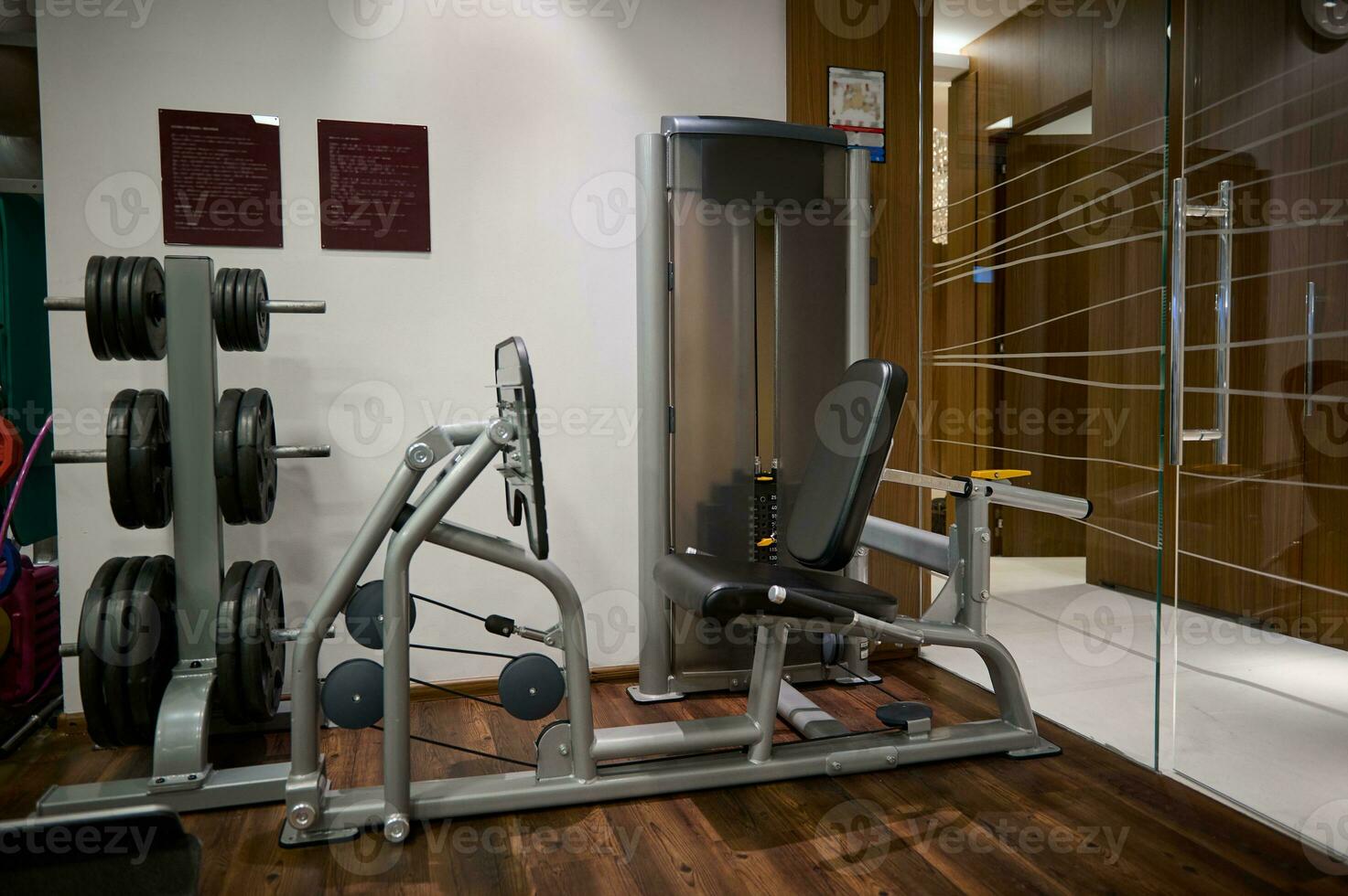 Photo of the indoor interior of a sports fitness room with dumbbells, kettlebells and exercise machines