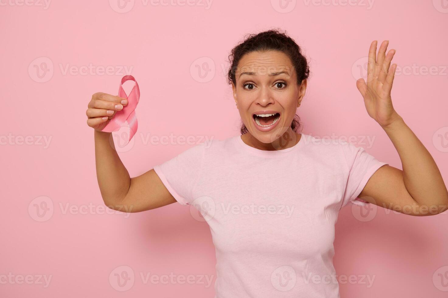 Woman in pink t-shirt holding cancer awareness pink ribbon. October Breast Cancer Awareness month, Woman in pink T- shirt with Pink Ribbon for supporting people living and illness. photo