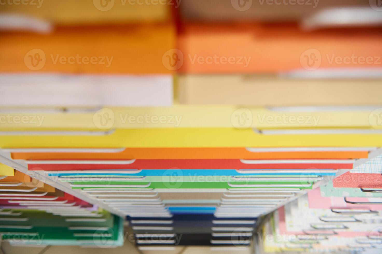 Top view color vibrant paper arranged on shelves, display for sale in stationary shop. Art store. Cardboard design paper photo