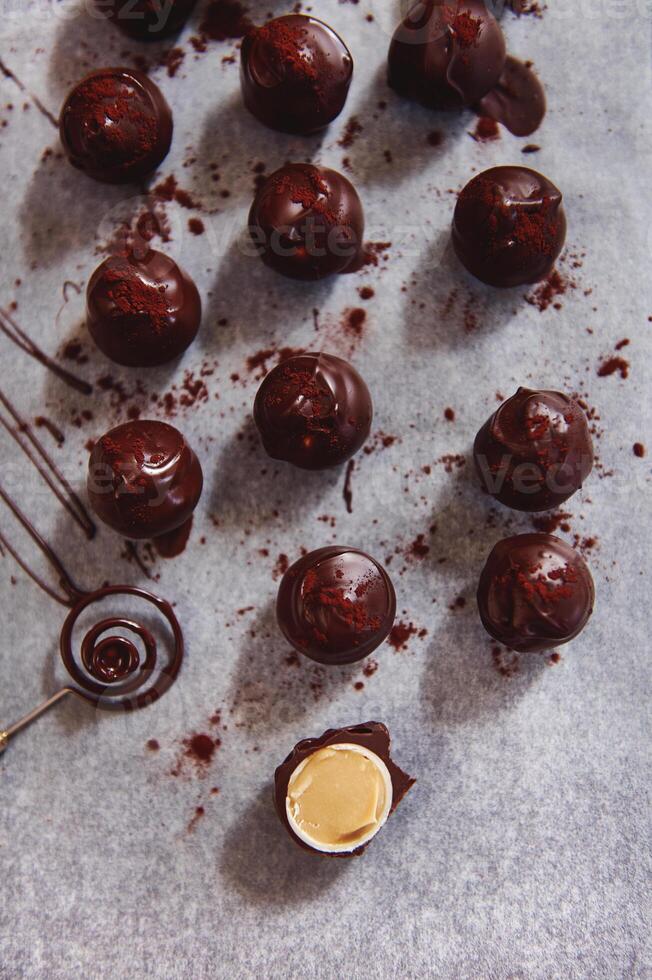 Top view of chocolate truffles on baking paper and a chocolate candy