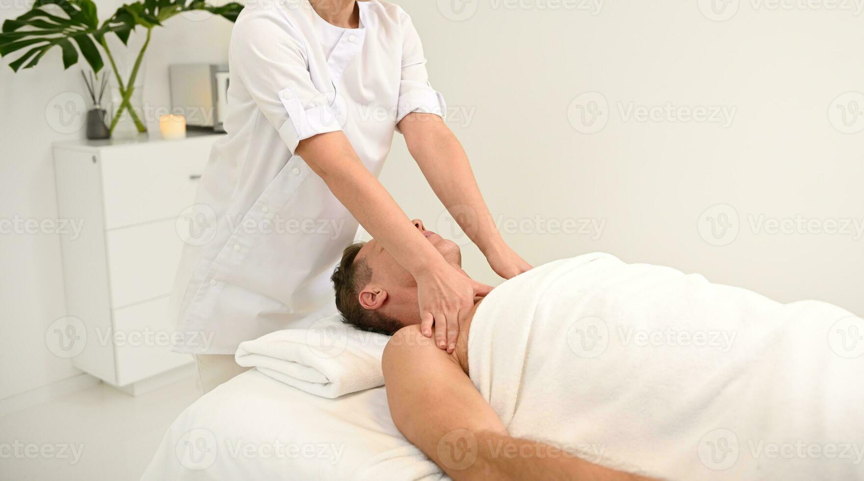 Man giving woman a shoulder massage Stock Photo