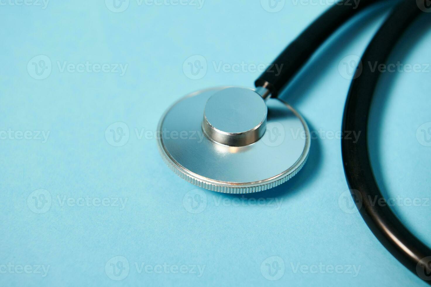 Closeup of a stethoscope on blue background with soft shadow. Copy space. Ponendoscope. Cropped view photo