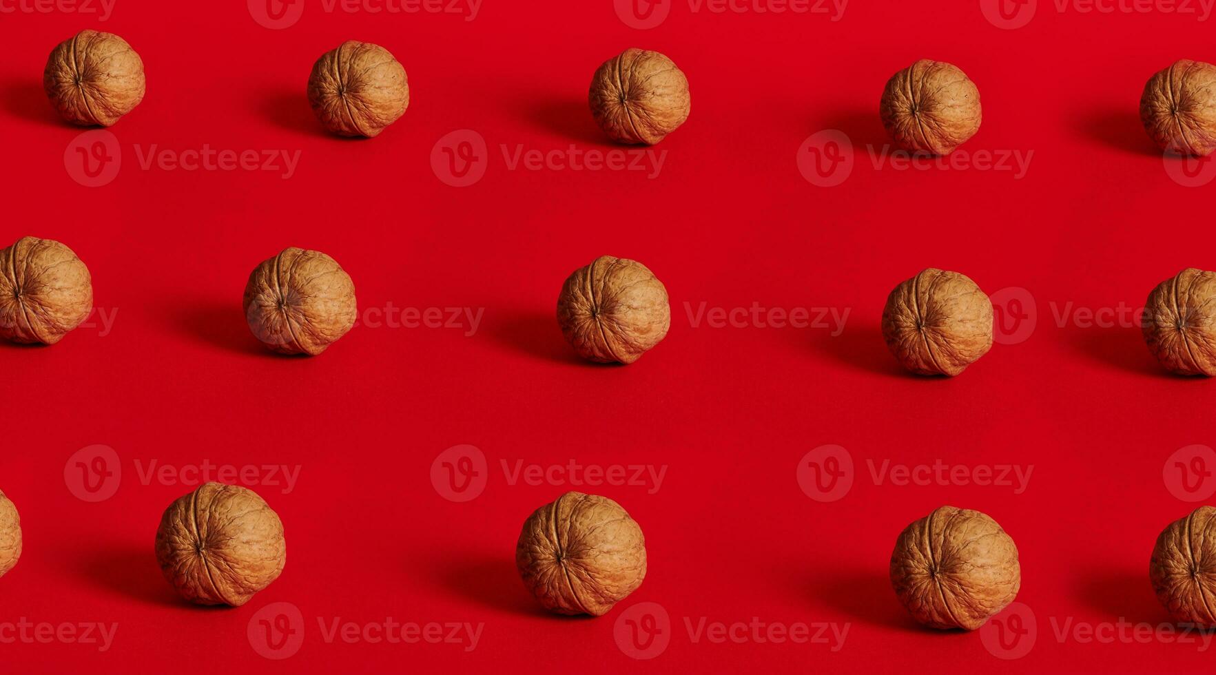 Walnut pattern on red background with space for text photo