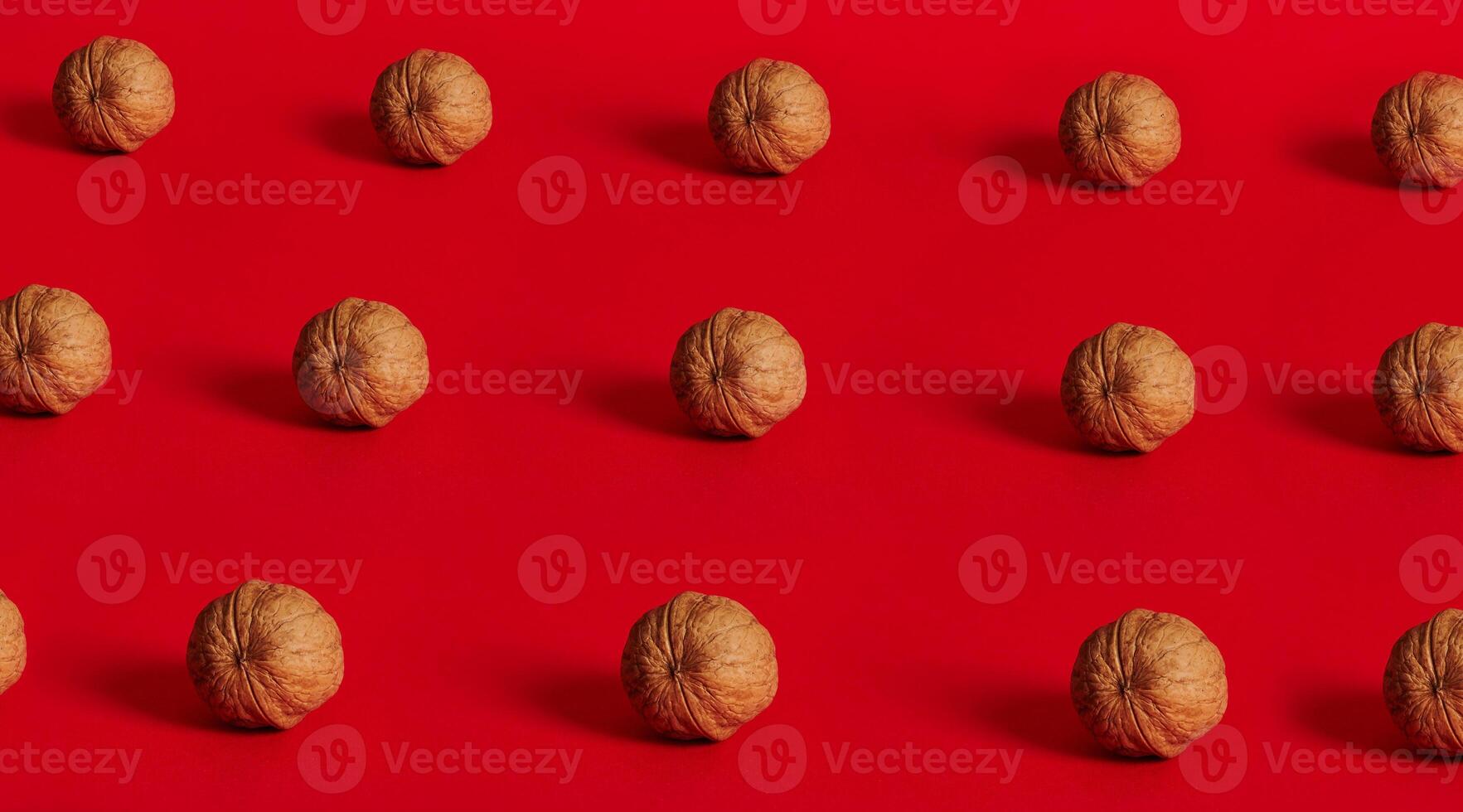 Walnut pattern on red background with space for text photo