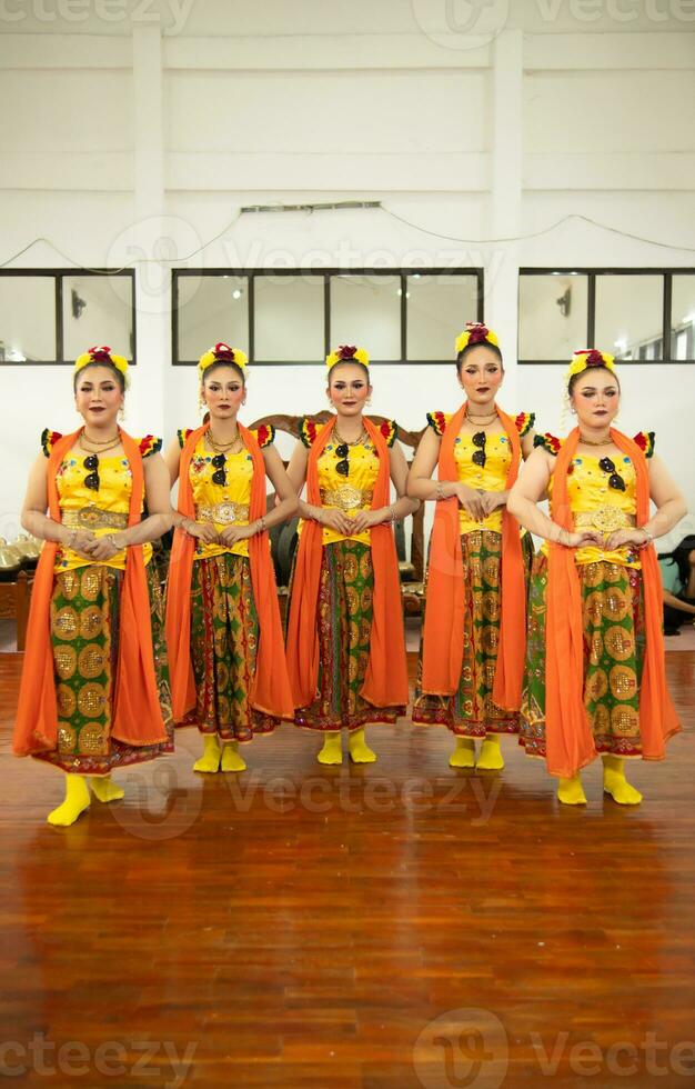 a group of traditional Sundanese dancers standing with their friends before the performance starts photo